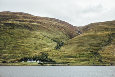 Countryside landscape against mountain range