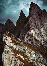 Low angle view of rocky mountains against sky