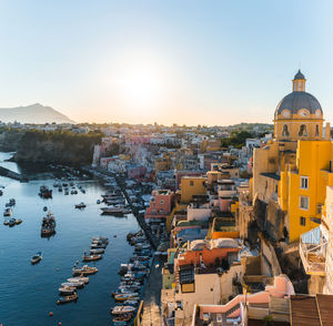 High angle view of townscape by sea against clear sky