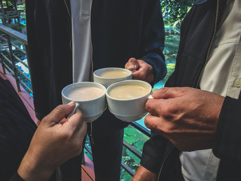 Close-up of man holding coffee cup