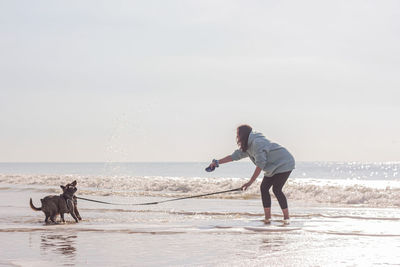 Side view of man standing at beach