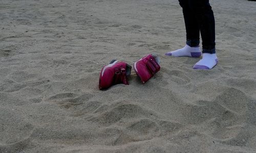 Low section of man wearing shoes