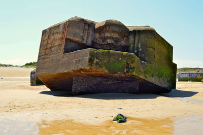 An old wrecked artillery casemate from the ii world war lies on the capbreton  beach. france 