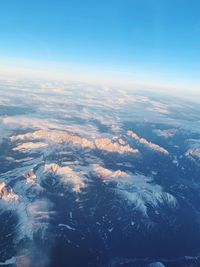 Aerial view of clouds over landscape against blue sky