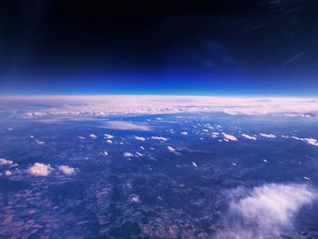 Aerial view of landscape against blue sky