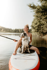 Full length of woman by lake against sky