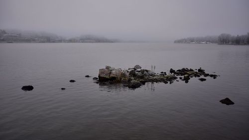 Scenic view of lake against sky during winter