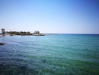 Scenic view of sea against clear blue sky