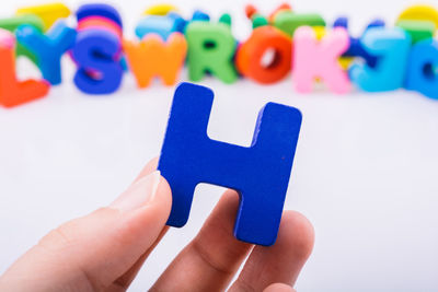 Close-up of hand holding alphabet h