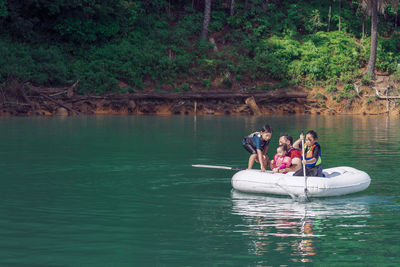 People in boat on lake