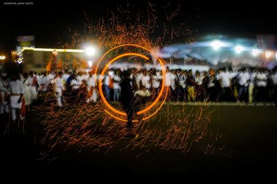 People watching firework display at night