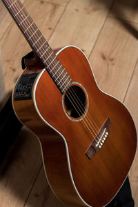 Close-up of guitar on hardwood floor