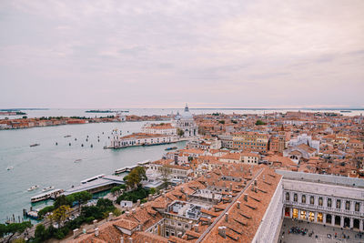 High angle view of buildings against cloudy sky