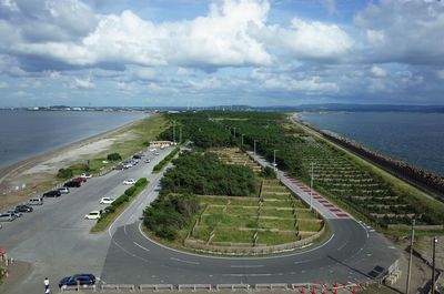 High angle view of cars on road by sea against sky