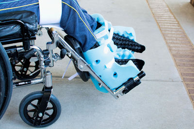 Low section of person sitting in wheelchair