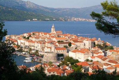 High angle view of townscape by sea