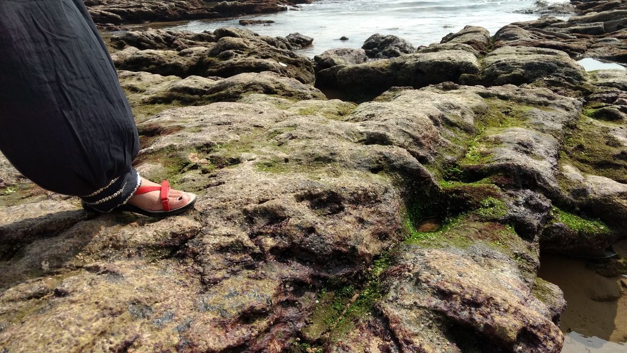 LOW SECTION OF PERSON ON THE BEACH