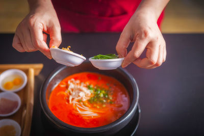 Midsection of woman preparing food on table