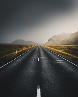 Empty road along countryside landscape