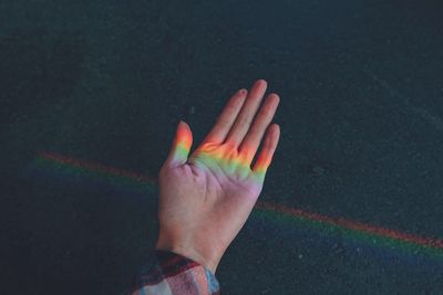 Close-up of hands holding multi colored hand