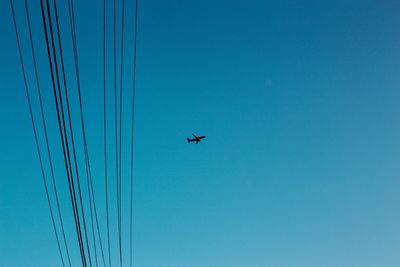 Low angle view of airplane flying against clear sky