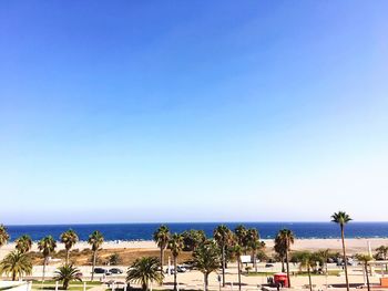Scenic view of beach against clear blue sky