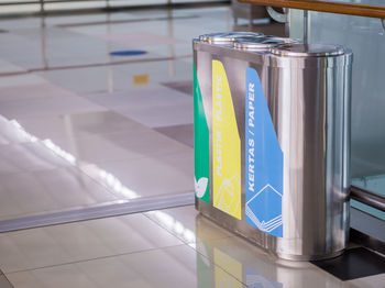 Metallic garbage cans on tiled floor