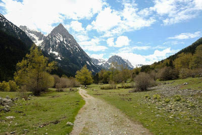 Road leading towards mountains against sky