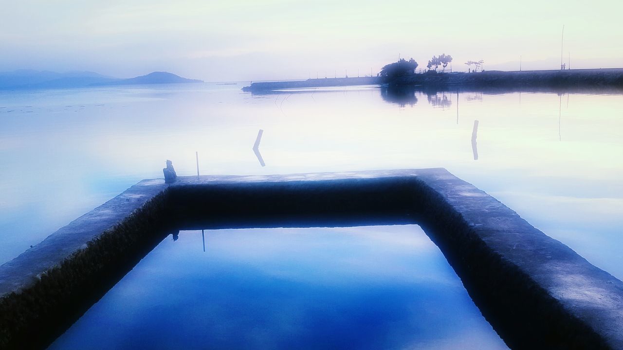 water, tranquility, sea, tranquil scene, sky, scenics, nature, reflection, lake, beauty in nature, waterfront, idyllic, calm, cloud - sky, outdoors, standing water, nautical vessel, no people, pier, non-urban scene