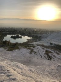 Scenic view of land against sky during sunset