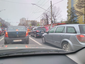 Traffic on road in city seen through car windshield