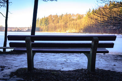 Scenic view of lake by trees against sky