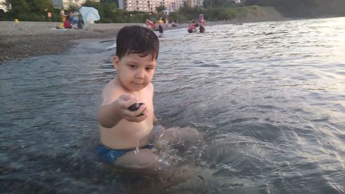 Cute boy swimming in water