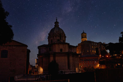 Low angle view of illuminated building against sky at night