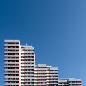 Low angle view of buildings against clear blue sky