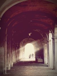 Woman walking in tunnel