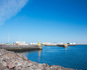 Harbour edge on edge of capital city. port in the distance.