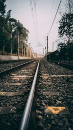 Surface level of railroad tracks against clear sky