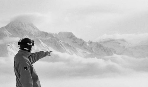 Woman standing on snow covered mountain