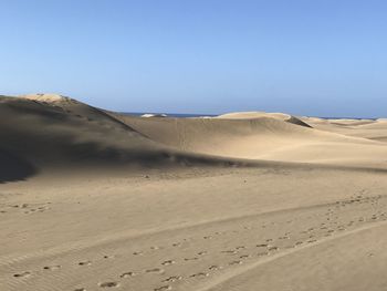 Scenic view of desert against clear sky