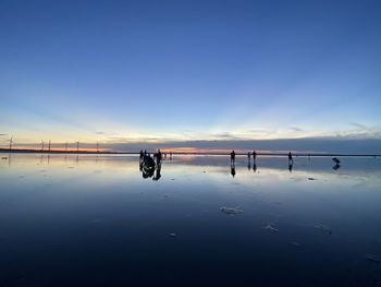 Scenic view of lake against sky during sunset