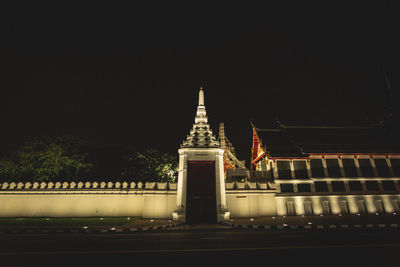 Illuminated building against sky at night