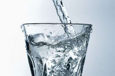 Close-up of water splashing against white background