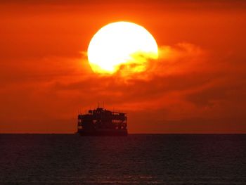 Scenic view of sea against orange sky