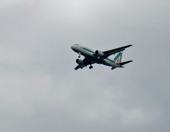 Low angle view of airplane flying in sky