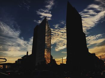 Low angle view of silhouette buildings against sky during sunset