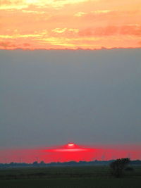 Scenic view of field against romantic sky at sunset