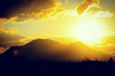 Scenic view of silhouette mountains against sky during sunset