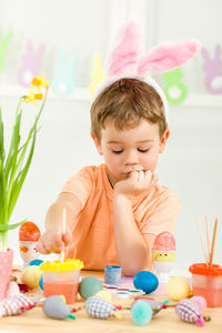 Cute girl playing with toys on table