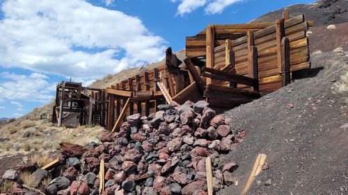 Stack of logs against sky